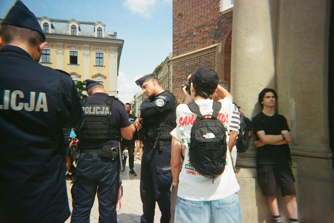 Journalist interviewing a resident outdoors in a Polish neighborhood