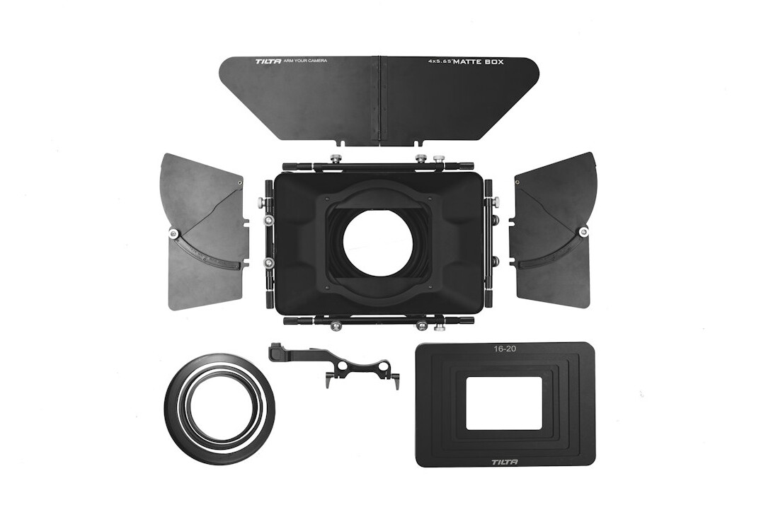 Flat lay of documentary camera equipment on a wooden table
